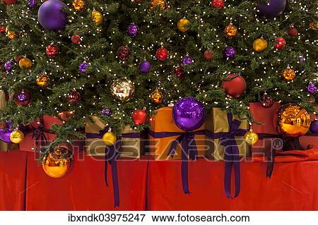 "Colourful Christmas baubles, fairy lights and gifts, Christmas tree" View Large Photo Image Stock Photo - "Colourful Christmas baubles, fairy lights and gifts, Christmas tree". Fotosearch