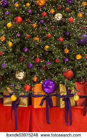 "Colourful Christmas baubles, fairy lights and gifts, Christmas tree" View Large Photo Image Stock Photo - "Colourful Christmas baubles, fairy lights and gifts, Christmas tree". Fotosearch
