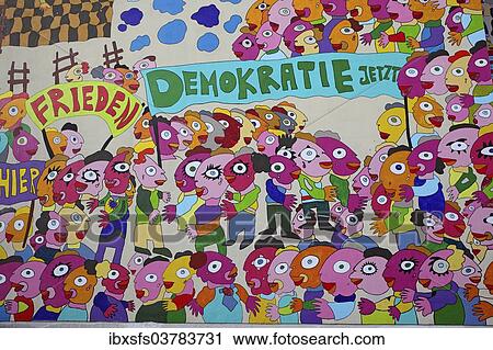 Stock Image - "Colourful mural with the words """"Frieden"""" and """"Demokratie jetzt"""", German for """"Peace"""" and """"Democracy now"""" on a wall of the Marriott Hotel Leipzig, Leipzig, Saxony, Germany, Europe". Fotosearch