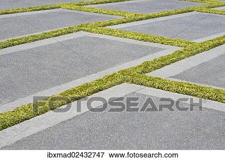 Concrete slabs with grass growing in the gaps View Large Photo Image Stock Photo - Concrete slabs with grass growing in the gaps. Fotosearch