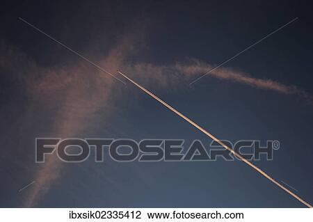 Contrails in the evening sky View Large Photo Image Stock Image - Contrails in the evening sky. Fotosearch