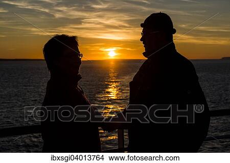 "Couple at the railing of a ship in front of the sunset on the North Atlantic coast of Thurso, Scotland, United Kingdom, Europe" View Large Photo Image Picture - "Couple at the railing of a ship in front of the sunset on the North Atlantic coast of Thurso, Scotland, United Kingdom, Europe". Fotosearch