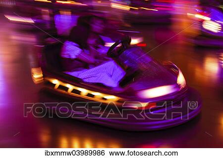 "Couple driving bumper car at night, Oktoberfest, Munich, Upper Bavaria, Bavaria, Germany, Europe" View Large Photo Image Stock Photograph - "Couple driving bumper car at night, Oktoberfest, Munich, Upper Bavaria, Bavaria, Germany, Europe". Fotosearch