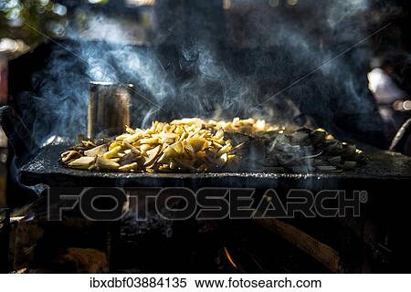 "Crisps frying over an open fire, sun rays penetrating the smoke, street cuisine, cookshop, Mrauk U, Sittwe District, Rakhine State, Myanmar, Asia" View Large Photo Image Stock Photography - "Crisps frying over an open fire, sun rays penetrating the smoke, street cuisine, cookshop, Mrauk U, Sittwe District, Rakhine State, Myanmar, Asia". Fotosearch