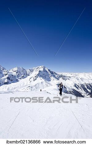 Stock Photograph - "Cross-country skier ascending Hintere Schoentaufspitze Mountain, Solda, overlooking Ortler and Zebru Mountains, Alto Adige, Italy, Europe". Fotosearch