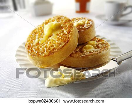 Crumpets or yeast cakes with butter View Large Photo Image Stock Image - Crumpets or yeast cakes with butter. Fotosearch