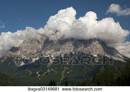 "Cumulus clouds looming over a mountain ridge, Ehrwald, Tyrol, Austria, Europe" View Large Photo Image Stock Image - "Cumulus clouds looming over a mountain ridge, Ehrwald, Tyrol, Austria, Europe". Fotosearch