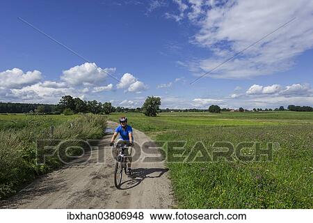"Cyclist near Ruciane-Nida, Warmian-Masurian Voivodeship, Poland, Europe" View Large Photo Image Stock Photo - "Cyclist near Ruciane-Nida, Warmian-Masurian Voivodeship, Poland, Europe". Fotosearch