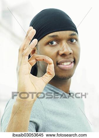 Dark-skinned man wearing a bandana and making an OK sign View Large Photo Image Stock Photography - Dark-skinned man wearing a bandana and making an OK sign. Fotosearch
