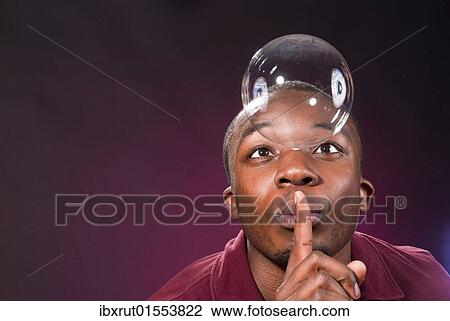 "Dark-skinned young man with soap-bubble, making a gesture of silence" View Large Photo Image Stock Image - "Dark-skinned young man with soap-bubble, making a gesture of silence". Fotosearch