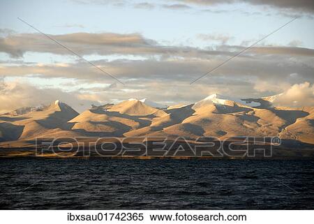 "Dark waters of Lake Manasarovar, a sacred lake in front of the Gurla Mandhata mountain range with shadows, Himalayas, Western Tibet, Tibet Autonomous Region, People's Republic of China, Asia" View Large Photo Image Stock Photography - "Dark waters of Lake Manasarovar, a sacred lake in front of the Gurla Mandhata mountain range with shadows, Himalayas, Western Tibet, Tibet Autonomous Region, People's Republic of China, Asia". Fotosearch