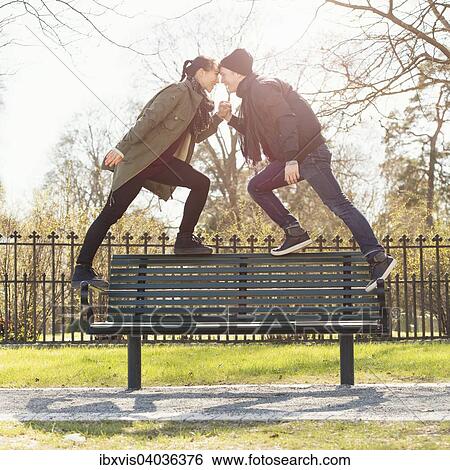 "Dating young couple standing on park bench, holding hands, Sweden, Europe" View Large Photo Image Stock Photograph - "Dating young couple standing on park bench, holding hands, Sweden, Europe". Fotosearch