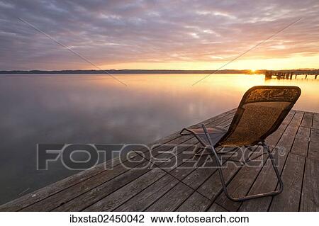 "Deckchair on a jetty, early morning at Lake Starnberg near Seeshaupt, Bavaria, Germany, Europe, PublicGround, Europe" View Large Photo Image Stock Image - "Deckchair on a jetty, early morning at Lake Starnberg near Seeshaupt, Bavaria, Germany, Europe, PublicGround, Europe". Fotosearch