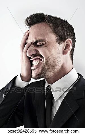 "Desperate young man wearing a suit covering his face with his hand, screaming" View Large Photo Image Stock Photography - "Desperate young man wearing a suit covering his face with his hand, screaming". Fotosearch