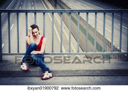 Desperate young woman sitting at a highway bridge View Large Photo Image Stock Image - Desperate young woman sitting at a highway bridge. Fotosearch