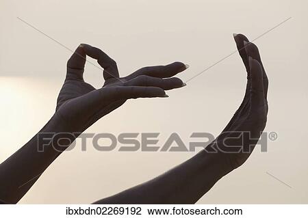 Stock Image - Detail of female hands forming Mudra gesture used in yoga practice meditation. Fotosearch