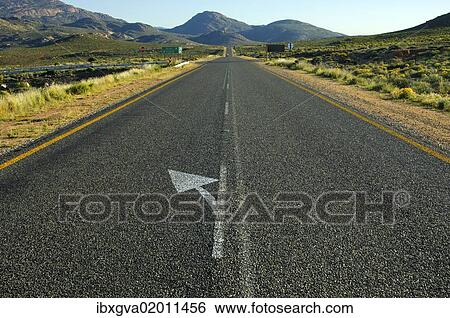 "Directional arrow to the left on the straight strip of asphalt at the National Road N7 near Springbok on the road north to the border with Namibia, Northern Cape Province, South Africa, Africa" View Large Photo Image Stock Photograph - "Directional arrow to the left on the straight strip of asphalt at the National Road N7 near Springbok on the road north to the border with Namibia, Northern Cape Province, South Africa, Africa". Fotosearch