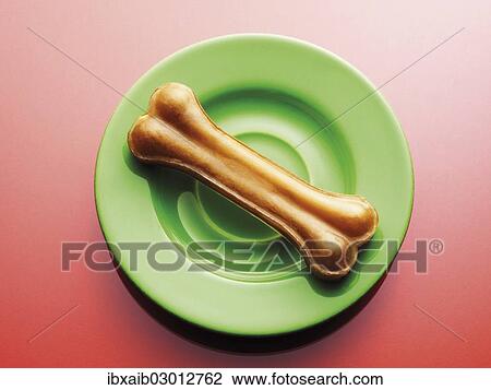 Dog bone on a green plate View Large Photo Image Stock Image - Dog bone on a green plate. Fotosearch