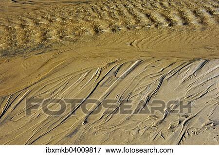Draining sea water leaving traces in the sand on the beach View Large Photo Image Stock Photo - Draining sea water leaving traces in the sand on the beach. Fotosearch