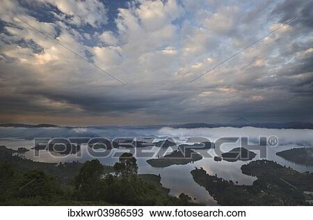 "Dramatic clouds and fog at sunrise above the islands of Bunyonyi Lake, Kisoro, southwestern Uganda" View Large Photo Image Stock Image - "Dramatic clouds and fog at sunrise above the islands of Bunyonyi Lake, Kisoro, southwestern Uganda". Fotosearch