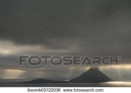 "Dramatic mood lighting, low clouds, rays of light falling on the sea, Koltur, Utoyggjar, Faroe Islands, Denmark, Europe" View Large Photo Image Stock Photograph - "Dramatic mood lighting, low clouds, rays of light falling on the sea, Koltur, Utoyggjar, Faroe Islands, Denmark, Europe". Fotosearch