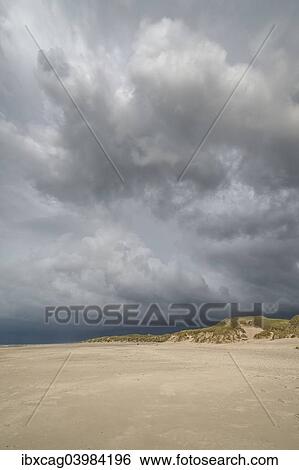 "Dramatic storm clouds over beach and dunes, Henne Strand, Region of Southern Denmark, Denmark, Europe" View Large Photo Image Stock Photograph - "Dramatic storm clouds over beach and dunes, Henne Strand, Region of Southern Denmark, Denmark, Europe". Fotosearch