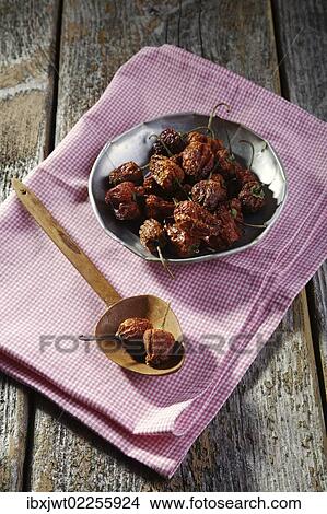 Dried mini-peppers lying on a rustic table View Large Photo Image Picture - Dried mini-peppers lying on a rustic table. Fotosearch