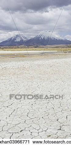 "Dried up salt lake with the volcanos Parinacota, left, and Pomerape, right, Putre, Arica and Parinacota Region, Chile, South America" View Large Photo Image Stock Image - "Dried up salt lake with the volcanos Parinacota, left, and Pomerape, right, Putre, Arica and Parinacota Region, Chile, South America". Fotosearch
