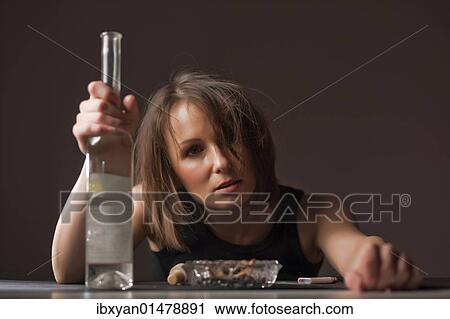 Stock Image - Drunk woman with brandy bottle. Fotosearch