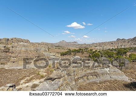 "Dry and wide erosional landscape with rocks and trees, Isalo National Park, at Ranohira, Madagascar, Africa" View Large Photo Image Picture - "Dry and wide erosional landscape with rocks and trees, Isalo National Park, at Ranohira, Madagascar, Africa". Fotosearch