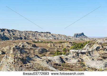 "Dry and wide erosional landscape with rocks and trees, Isalo National Park, at Ranohira, Madagascar, Africa" View Large Photo Image Stock Image - "Dry and wide erosional landscape with rocks and trees, Isalo National Park, at Ranohira, Madagascar, Africa". Fotosearch