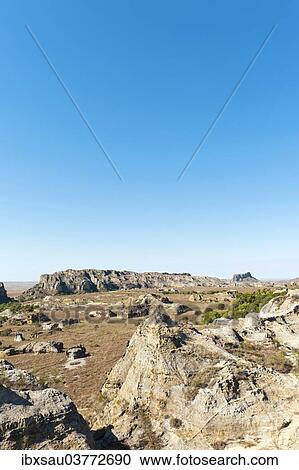 "Dry and wide erosional landscape with rocks and trees, Isalo National Park, at Ranohira, Madagascar, Africa" View Large Photo Image Stock Image - "Dry and wide erosional landscape with rocks and trees, Isalo National Park, at Ranohira, Madagascar, Africa". Fotosearch