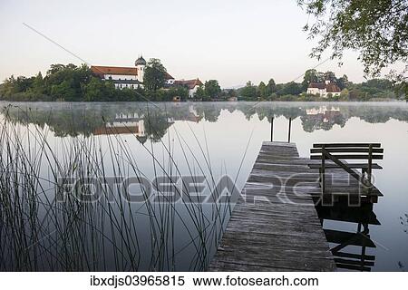 Stock Photography - "Early morning at Seeon Abbey on an island in Seeoner See Lake, Seeon-Seebruck, Chiemgau, Upper Bavaria, Bavaria, Germany, Europe". Fotosearch