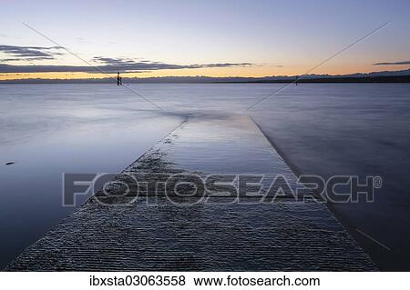 "Early morning, dawn with lighthouse and Alps, at Hoernle, Lake Constanz, Konstanz, Baden-Wurttemberg, Germany, Europe" View Large Photo Image Stock Photo - "Early morning, dawn with lighthouse and Alps, at Hoernle, Lake Constanz, Konstanz, Baden-Wurttemberg, Germany, Europe". Fotosearch