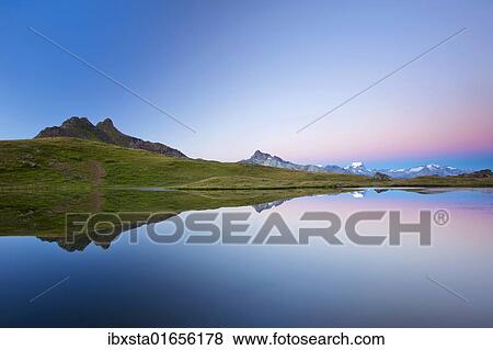 "Early morning mood on Lake Berglimatt with a reflection of the Glarus Alps, Canton of Glarus, Switzerland, Europe" View Large Photo Image Stock Photo - "Early morning mood on Lake Berglimatt with a reflection of the Glarus Alps, Canton of Glarus, Switzerland, Europe". Fotosearch