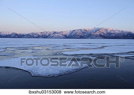 Stock Photo - "Early morning mood on the frozen Lake Kussharo with ice floes in the front, Akan-Nationalpark, Kawayu Onsen, Hokkaido, Japan, Asia". Fotosearch