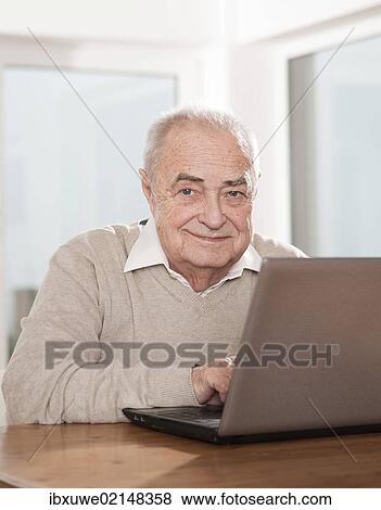 Elderly man using a PC View Large Photo Image Stock Photo - Elderly man using a PC. Fotosearch