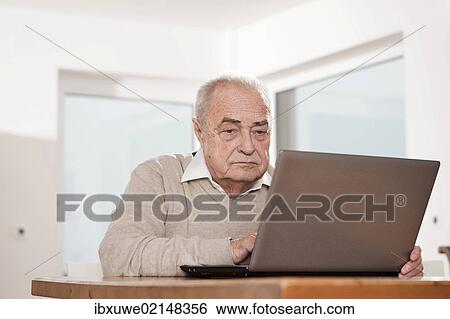 Elderly man using a PC View Large Photo Image Stock Photograph - Elderly man using a PC. Fotosearch
