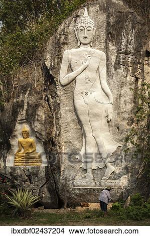 "Elderly woman standing in front of a Buddha sculpture, Buddha Cave, Mae Cham, Chiang Rai Province, Northern Thailand, Thailand, Asia" View Large Photo Image Picture - "Elderly woman standing in front of a Buddha sculpture, Buddha Cave, Mae Cham, Chiang Rai Province, Northern Thailand, Thailand, Asia". Fotosearch