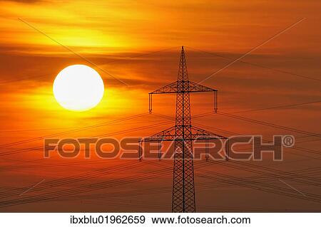 "Electric power transmission lines, electricity pylon, with the setting sun, Beinstein near Stuttgart, Baden-Wuerttemberg, Germany, Europe" View Large Photo Image Stock Photo - "Electric power transmission lines, electricity pylon, with the setting sun, Beinstein near Stuttgart, Baden-Wuerttemberg, Germany, Europe". Fotosearch