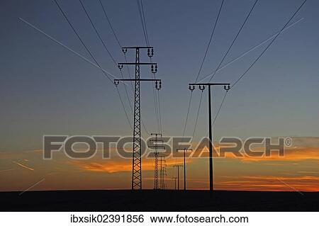 Stock Photograph - "Electricity pylons at sunset, dusk, Upper Swabia, Baden-Wuerttemberg, Germany, Europe". Fotosearch