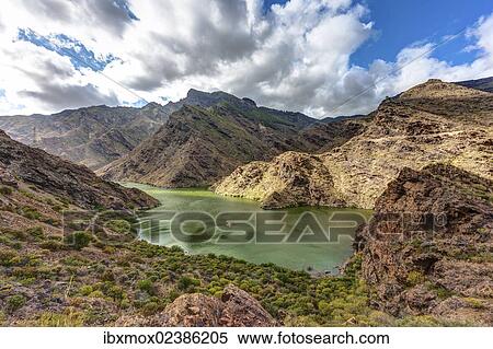 "Embalse Presa del Parralillo reservoir, also called """"the green lake"""", in the mountains of Caldera de Tejeda, also called a """"petrified storm"""", Artenara Region, Gran Canaria, Canary Islands, Spain, Europe, PublicGround, Europe" View Large Photo Image Stock Photography - "Embalse Presa del Parralillo reservoir, also called """"the green lake"""", in the mountains of Caldera de Tejeda, also called a """"petrified storm"""", Artenara Region, Gran Canaria, Canary Islands, Spain, Europe, PublicGround, Europe". Fotosearch