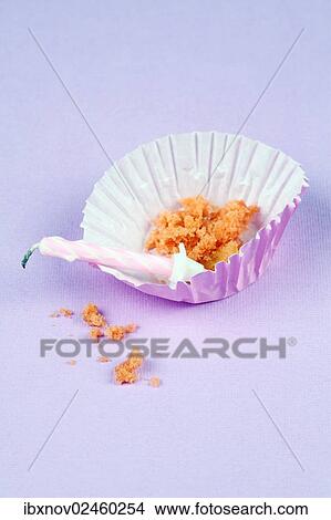 Empty cupcake or muffin case with crumbs and candle View Large Photo Image Picture - Empty cupcake or muffin case with crumbs and candle. Fotosearch