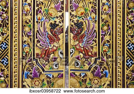 Stock Image - "Entrance gate decorated with wood carving, Ubud, Bali, Indonesia, Asia". Fotosearch