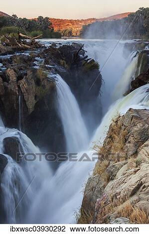 Stock Image - "Epupa Falls, waterfall, about 40 m, formed from the Kunene River on the border with Angola, Epupa, Kaokoland, Kunene Region, Namibia, Africa". Fotosearch