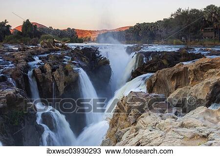 Stock Image - "Epupa Falls, waterfall, about 40 m, formed from the Kunene River on the border with Angola, Epupa, Kaokoland, Kunene Region, Namibia, Africa". Fotosearch