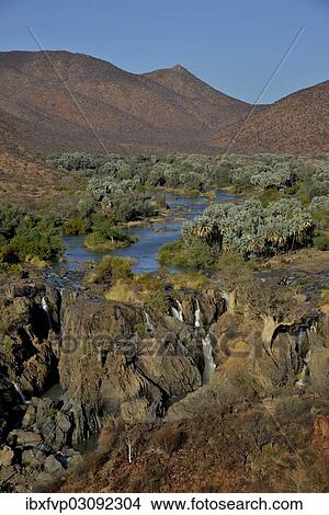 "Epupa Falls, waterfalls of the Kunene River on the Namibian-Angolan border, Kunene Region, Namibia, Africa" View Large Photo Image Picture - "Epupa Falls, waterfalls of the Kunene River on the Namibian-Angolan border, Kunene Region, Namibia, Africa". Fotosearch