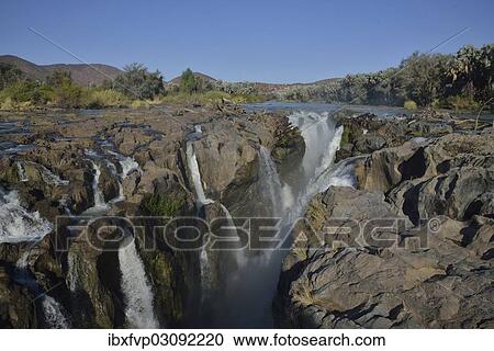 "Epupa Falls, waterfalls of the Kunene River on the Namibian-Angolan border, Kunene Region, Namibia, Africa" View Large Photo Image Stock Image - "Epupa Falls, waterfalls of the Kunene River on the Namibian-Angolan border, Kunene Region, Namibia, Africa". Fotosearch