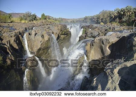 Stock Image - "Epupa Falls, waterfalls of the Kunene River on the Namibian-Angolan border, Kunene Region, Namibia, Africa". Fotosearch