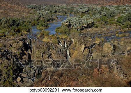 Stock Image - "Epupa Falls, waterfalls of the Kunene River on the Namibian-Angolan border, Kunene Region, Namibia, Africa". Fotosearch